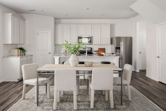 dining room featuring dark hardwood / wood-style flooring