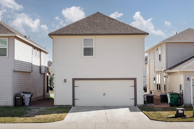 exterior space featuring central AC and a garage