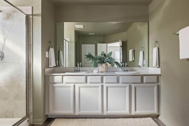 bathroom featuring an enclosed shower and vanity