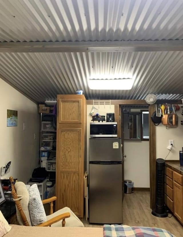 kitchen with stainless steel appliances and light hardwood / wood-style floors