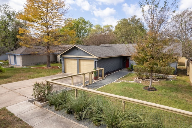 view of front facade with a front yard and a garage