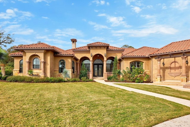 mediterranean / spanish house with a front yard