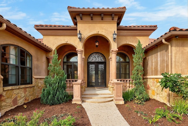 view of exterior entry featuring french doors