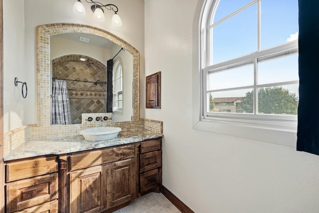 bathroom with vanity, a wealth of natural light, decorative backsplash, and a shower with curtain