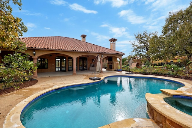 view of pool with a patio and an in ground hot tub