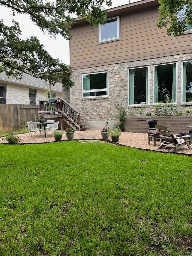 back of house with a lawn