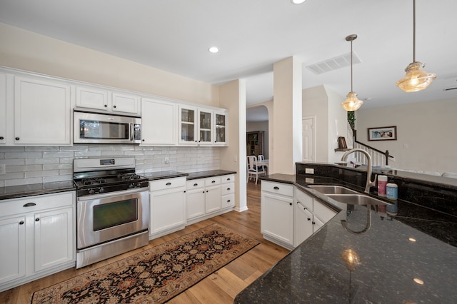 kitchen featuring stainless steel appliances, white cabinets, and sink