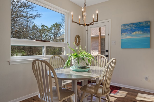 dining space featuring a notable chandelier and dark hardwood / wood-style floors