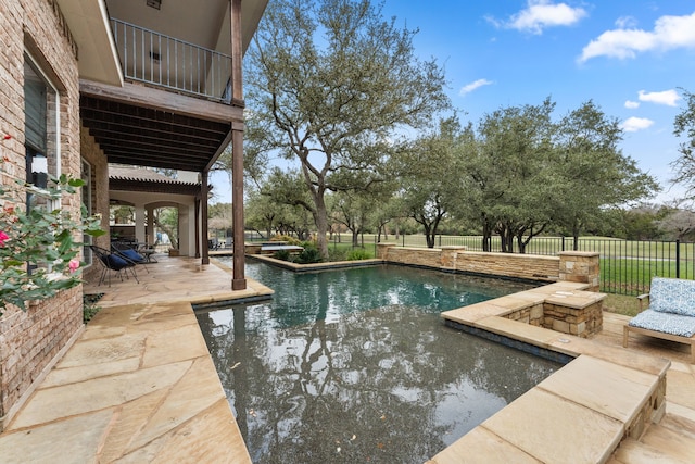 view of pool featuring an outdoor fire pit and a patio area