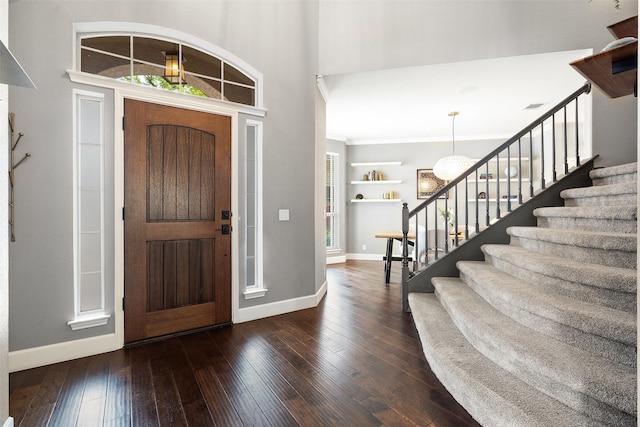 entrance foyer with crown molding and dark hardwood / wood-style floors