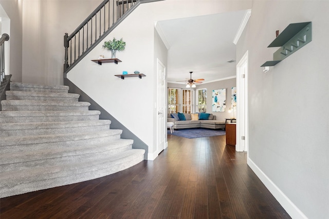 interior space with hardwood / wood-style floors, ceiling fan, and ornamental molding