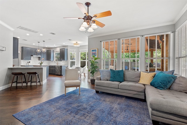 living room with sink, ornamental molding, ceiling fan, and dark hardwood / wood-style floors