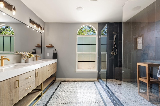 bathroom featuring tiled shower and vanity