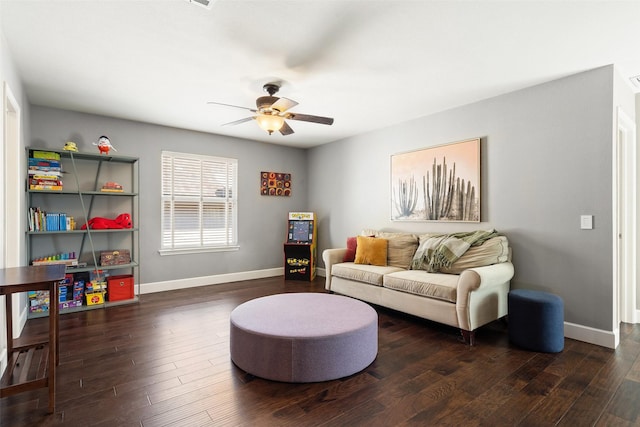 living room featuring ceiling fan and dark hardwood / wood-style flooring