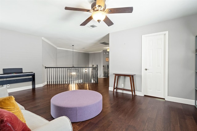 sitting room with dark hardwood / wood-style floors and ceiling fan with notable chandelier