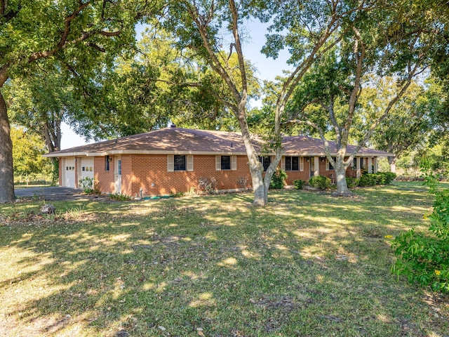 view of front facade with a front yard and a garage