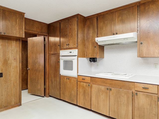 kitchen featuring white appliances and a textured ceiling