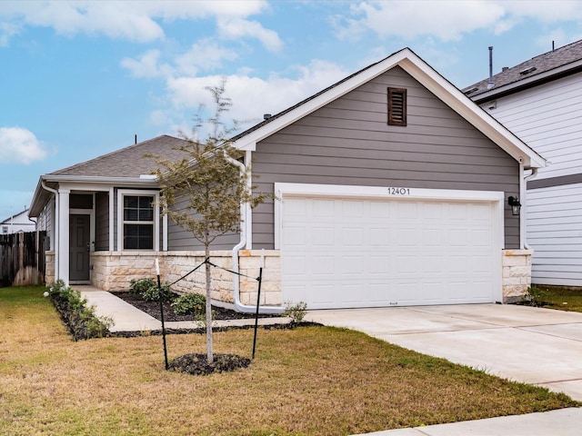 single story home featuring a front yard, stone siding, driveway, and an attached garage