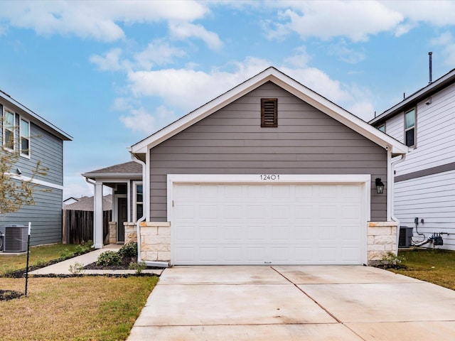 view of front of house featuring central AC, a front yard, and a garage