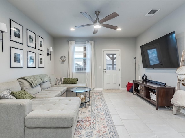 living room with light tile patterned floors, visible vents, baseboards, ceiling fan, and recessed lighting