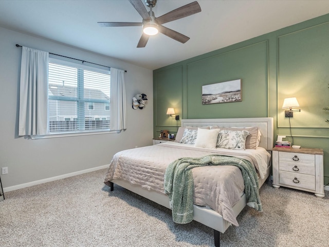 carpeted bedroom featuring baseboards and a ceiling fan