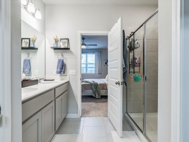 ensuite bathroom featuring double vanity, a stall shower, connected bathroom, a sink, and tile patterned floors