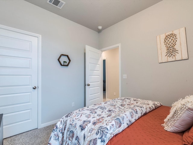 carpeted bedroom featuring visible vents and baseboards