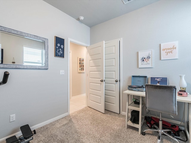 carpeted office with visible vents and baseboards