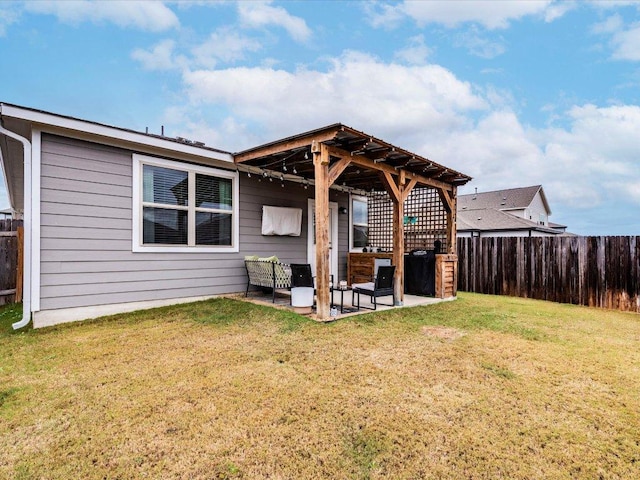 back of house with fence, a pergola, a lawn, and a patio