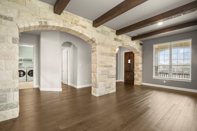 empty room featuring separate washer and dryer, beamed ceiling, and dark hardwood / wood-style floors