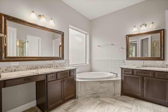 3816 Tango Ct, Leander, TX 78641 - bathroom featuring two vanities, a garden tub, marble look tile flooring, and a shower