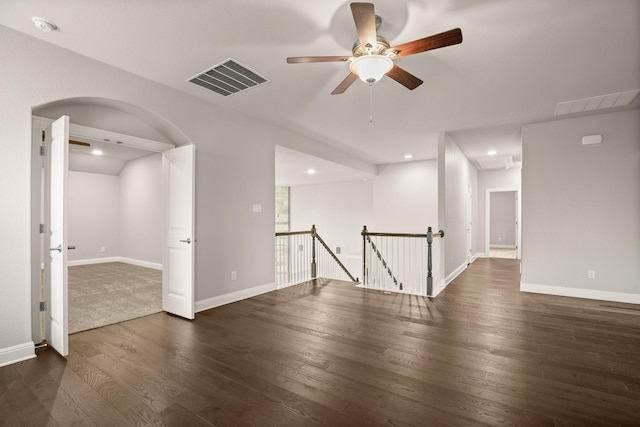 spare room featuring ceiling fan and dark hardwood / wood-style flooring