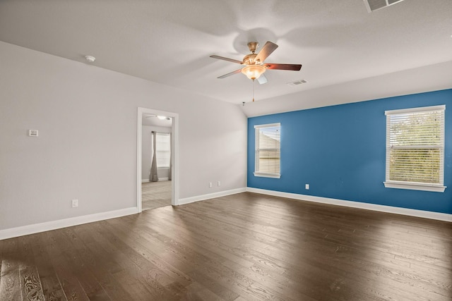 empty room featuring dark wood-type flooring and ceiling fan