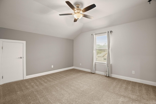 additional living space with ceiling fan, vaulted ceiling, and carpet flooring