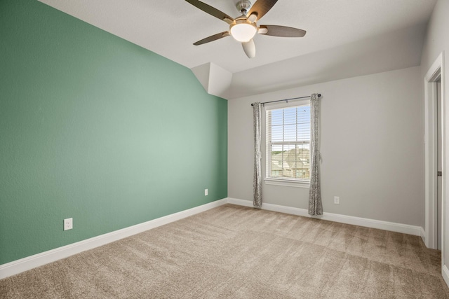 spare room featuring ceiling fan and light colored carpet