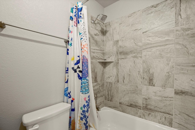 bathroom featuring shower / tub combo with curtain and toilet