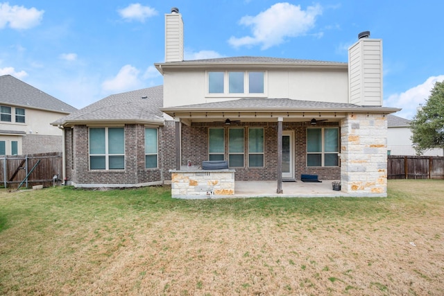 back of property with a patio area and a lawn