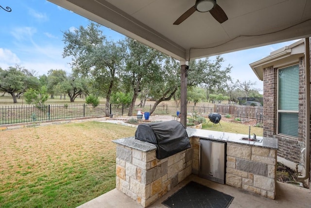 3816 Tango Ct, Leander, TX 78641 - fenced backyard with an outdoor kitchen and a ceiling fan