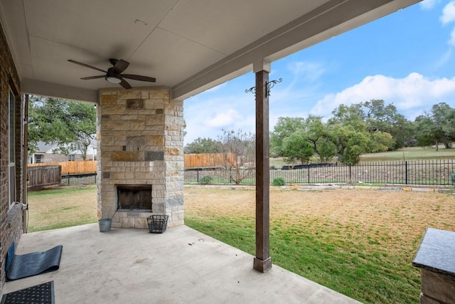3816 Tango Ct, Leander, TX 78641 - fenced backyard with an outdoor stone fireplace, a patio, and a ceiling fan