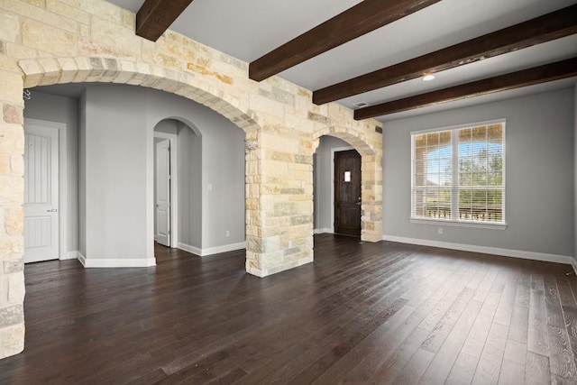 3816 Tango Ct, Leander, TX 78641 - empty room featuring dark wood-type flooring, beam ceiling, and arched walkways