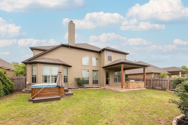 974 Clear Springs Holw, Buda, TX 78610 - rear view of house with a hot tub and a chimney