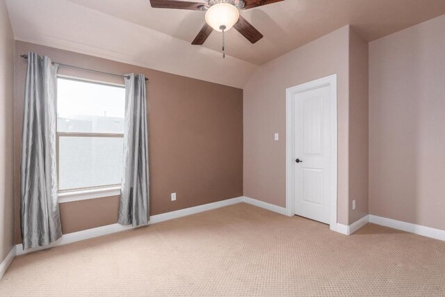974 Clear Springs Holw, Buda, TX 78610 - spare room with ceiling fan, light carpet, baseboards, and vaulted ceiling
