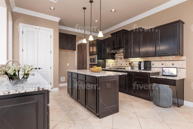 974 Clear Springs Holw, Buda, TX 78610 - kitchen with stainless steel microwave, ornamental molding, tasteful backsplash, hanging light fixtures, and light stone countertops