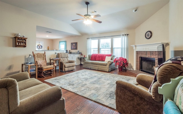 living room featuring a fireplace, dark wood-type flooring, ceiling fan, and vaulted ceiling