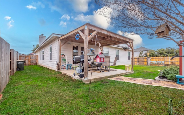 back of property featuring a patio area and a yard