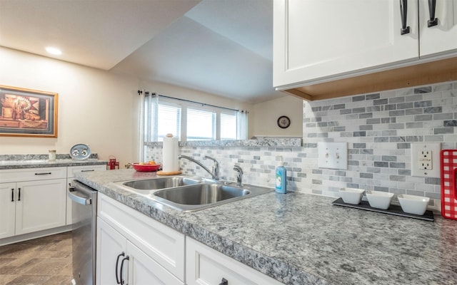 kitchen with white cabinets, dishwasher, decorative backsplash, and sink