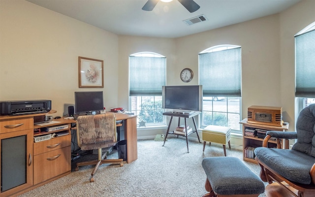 carpeted home office with ceiling fan