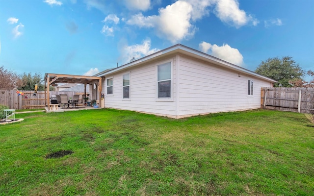 back of property with a yard and a patio