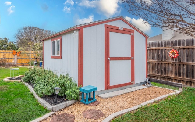 view of outbuilding featuring a lawn