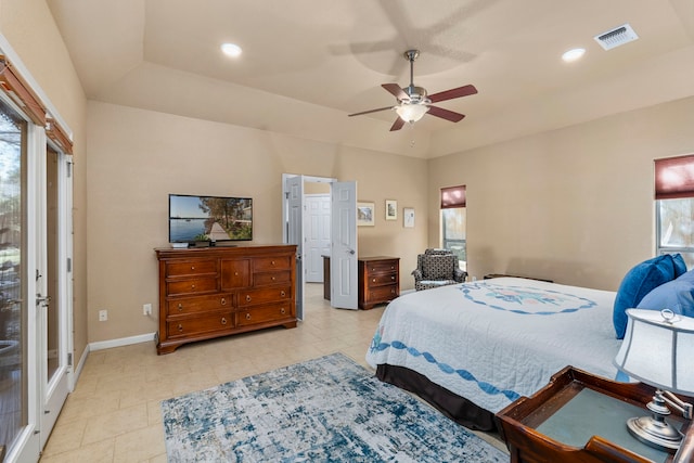 bedroom with ceiling fan and a raised ceiling